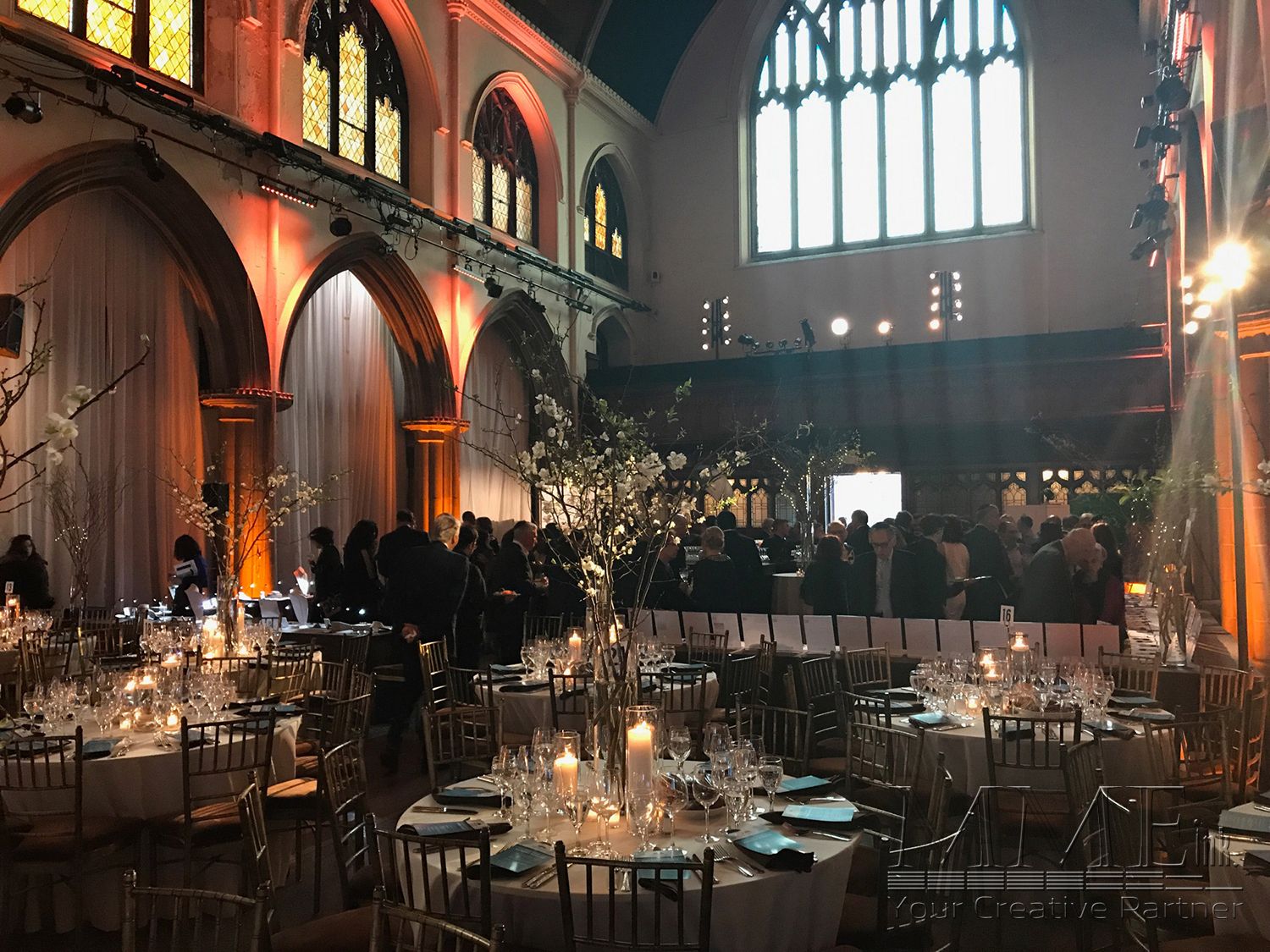 A previous evening gathering in FourthU’s sanctuary, with warm light and tables under Gothic arches.
