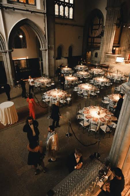 A balcony view of guests and tables inside the sanctuary.
